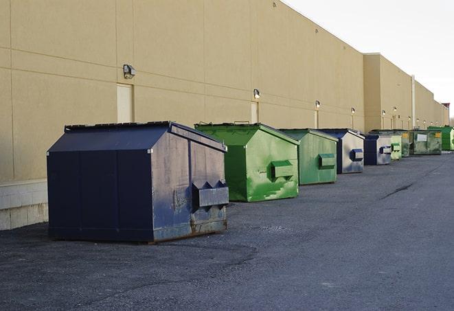 large construction waste containers in a row at a job site in Carthage TX